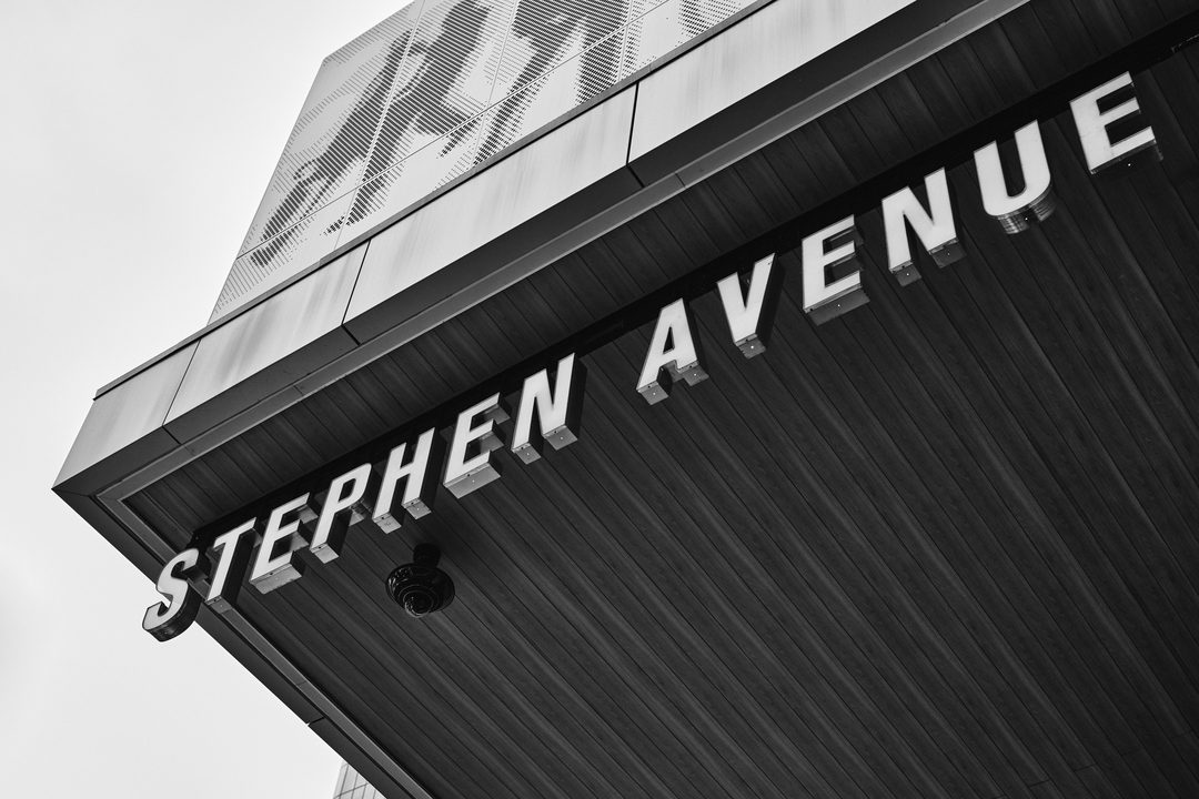 Stephen Avenue sign in downtown Calgary — black and white street photography