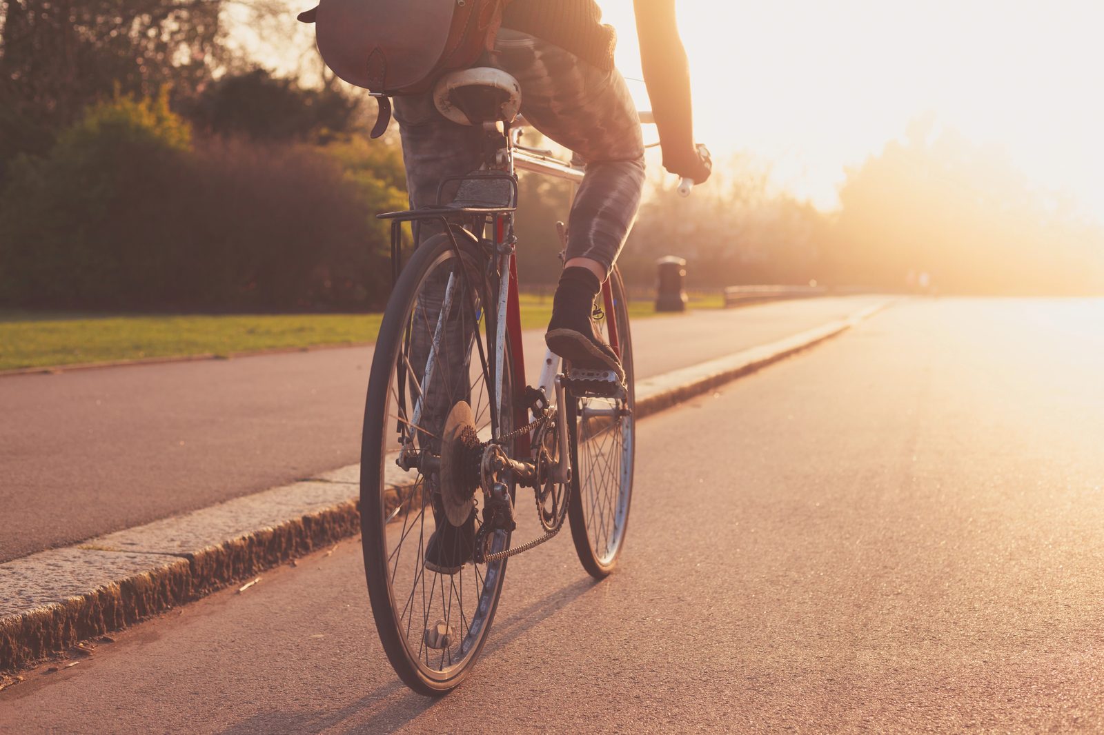 Cyclist riding through park at golden sunset — lifestyle photography Calgary