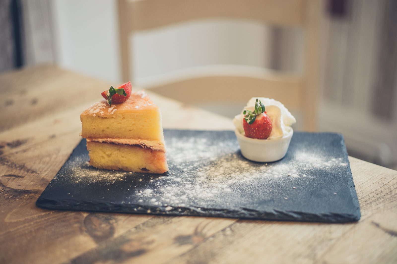 Sponge cake with strawberry and cream on slate — food photography Calgary
